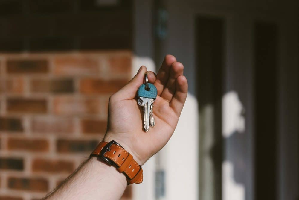 110141 30 closeup person hand holding keys with blurred background