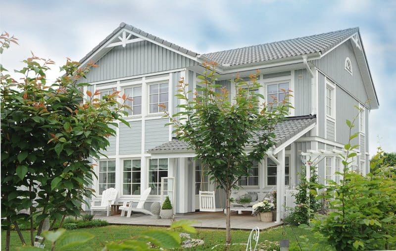 Une maison avec un extérieur bleu et des garnitures blanches.