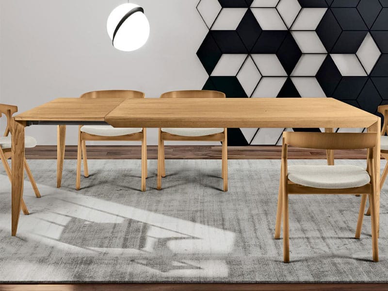 Une table à manger et des chaises modernes dans une pièce en noir et blanc.