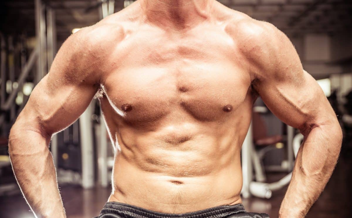 Un homme dans une salle de sport posant pour une photo.