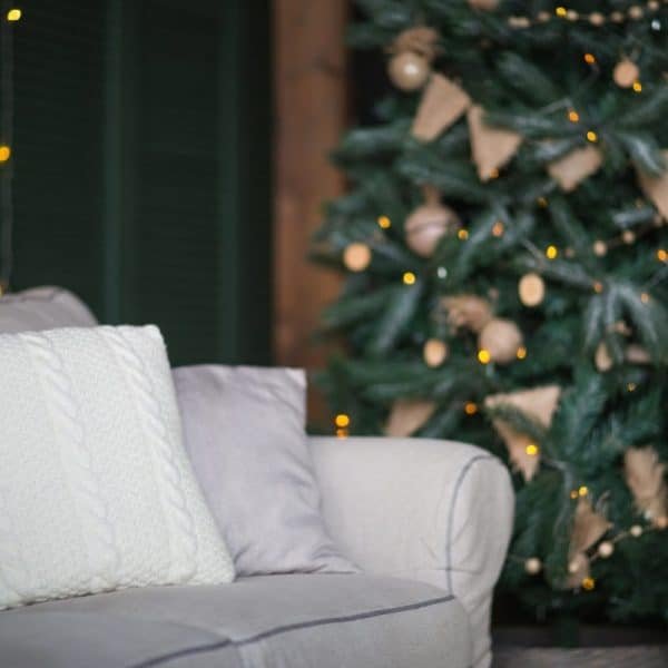 Christmas decor, home textiles. background with christmas three and sofa