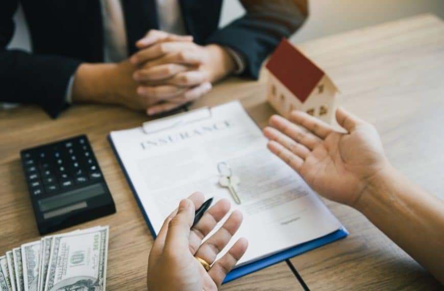 Customers buying houses are negotiating about the cost of home insurance with agents.