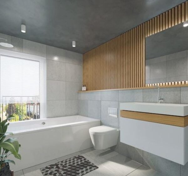 Salle de bains moderne avec une baignoire, des toilettes murales, un lavabo flottant, un grand miroir, des murs en carrelage gris, des touches de bois et une plante près de la fenêtre.