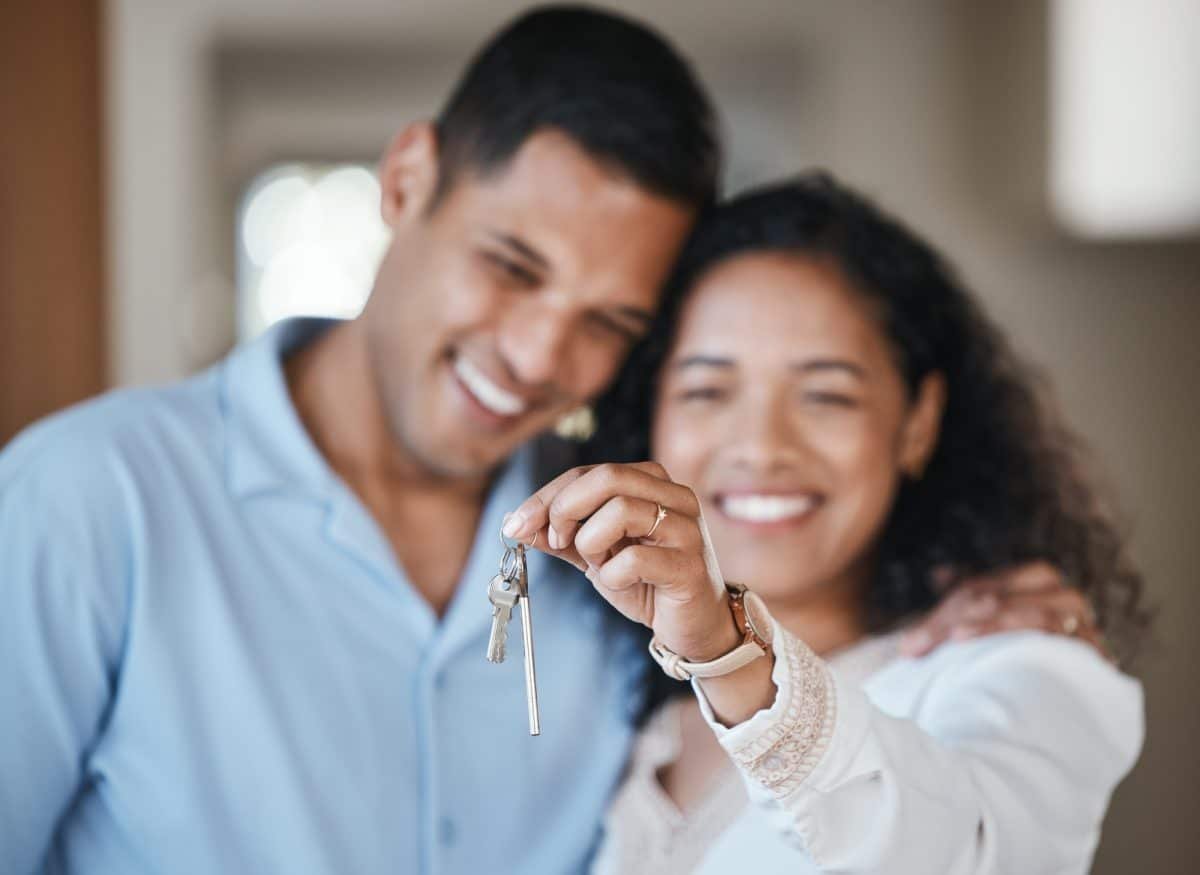 House keys, new home or happy couple hug in real estate, property investment or buying an apartment