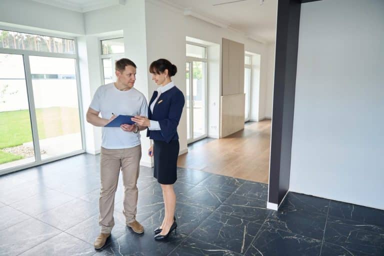 Man signs documents for buying a house