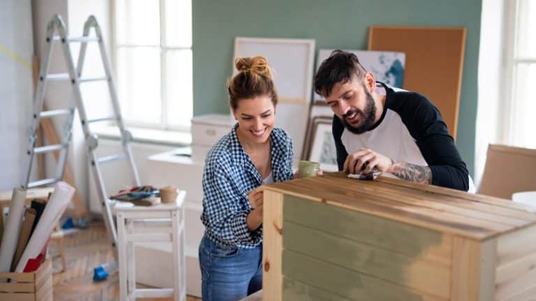 Mid adults couple painting furniture indoors at home, relocation and diy concept