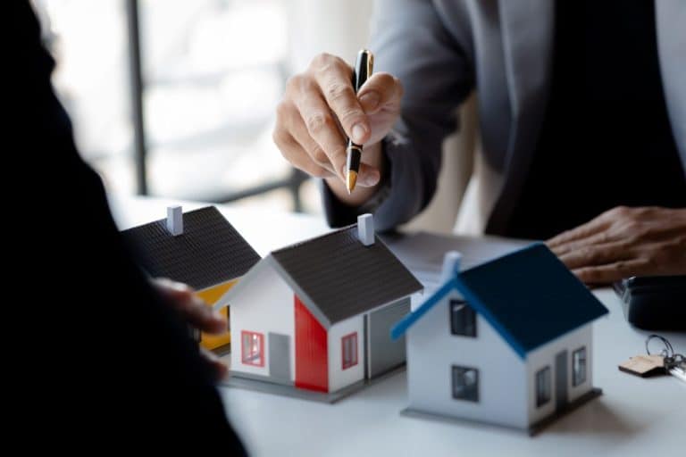 Real estate agents explain models of housing estates in projects.