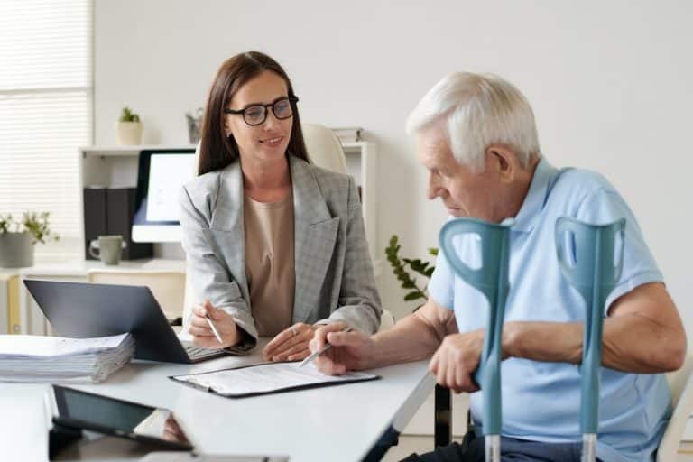 Senior man signing insurance contract