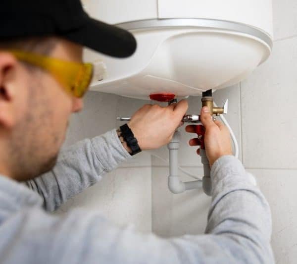 travailleur reparant chauffe eau