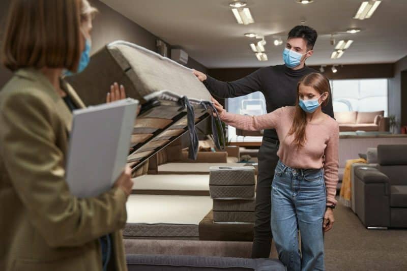 Two concentrated buyers shopping for convertible sofa-bed
